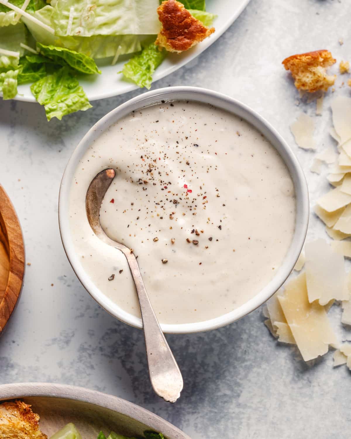Caesar Dressing in bowl with spoon.